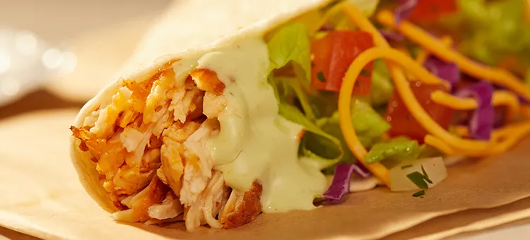 Cantina Chicken Soft Taco: A warm flour tortilla filled with savory, slow-roasted chicken, lettuce, shredded purple…