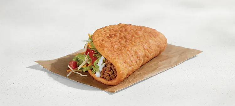 Chalupa Supreme: A warm-and-flaky flatbread shell filled with seasoned beef, lettuce, diced tomaotes, a blend of…