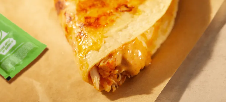 Cantina Chicken Crispy Taco: A freshly fried white-corn taco shell filled with savory, slow-roasted chicken, a blend of…